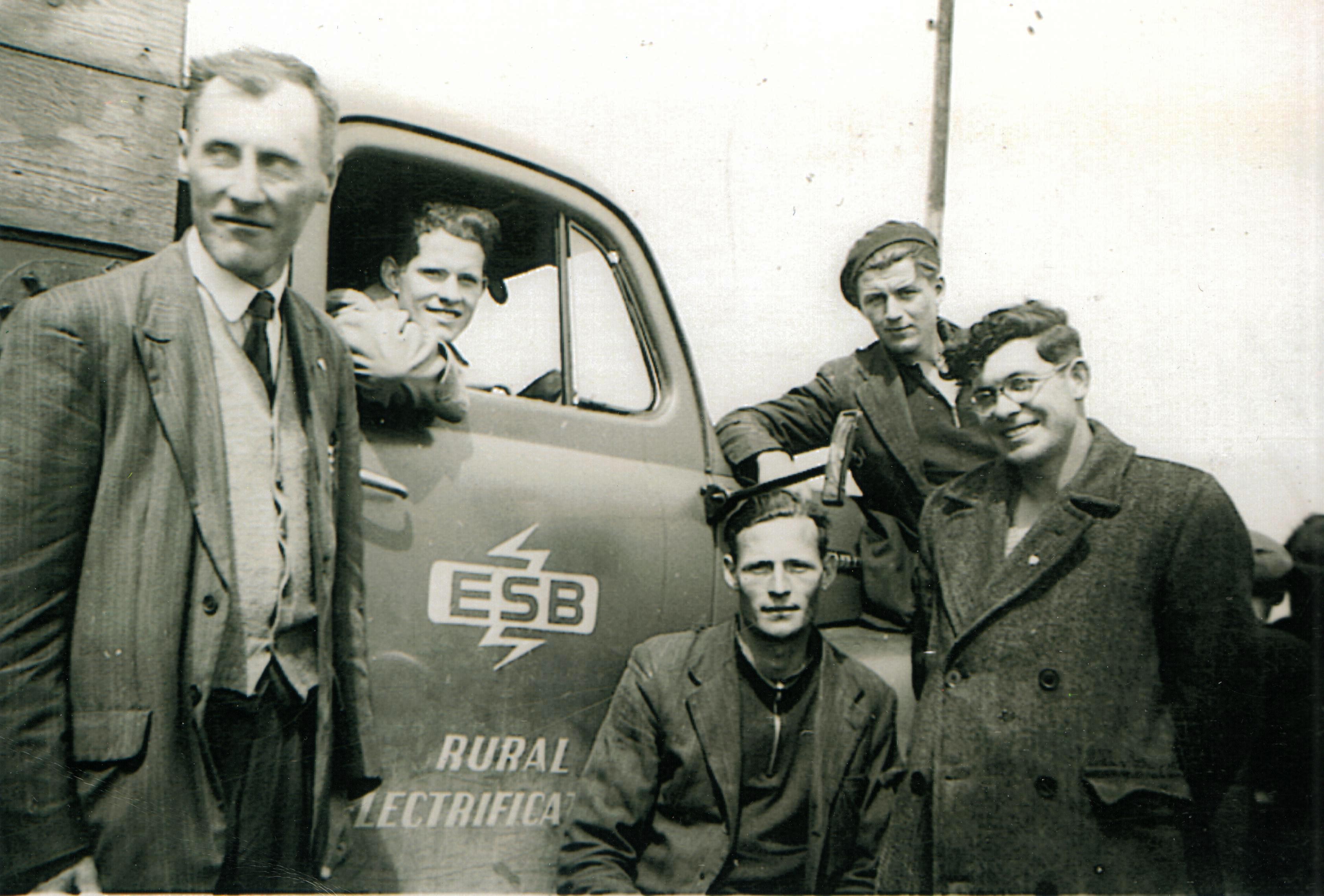 Tim Slevin with four ESB colleagues gathered around an ESB Rural Electrification vehicle displaying the ESB logo.