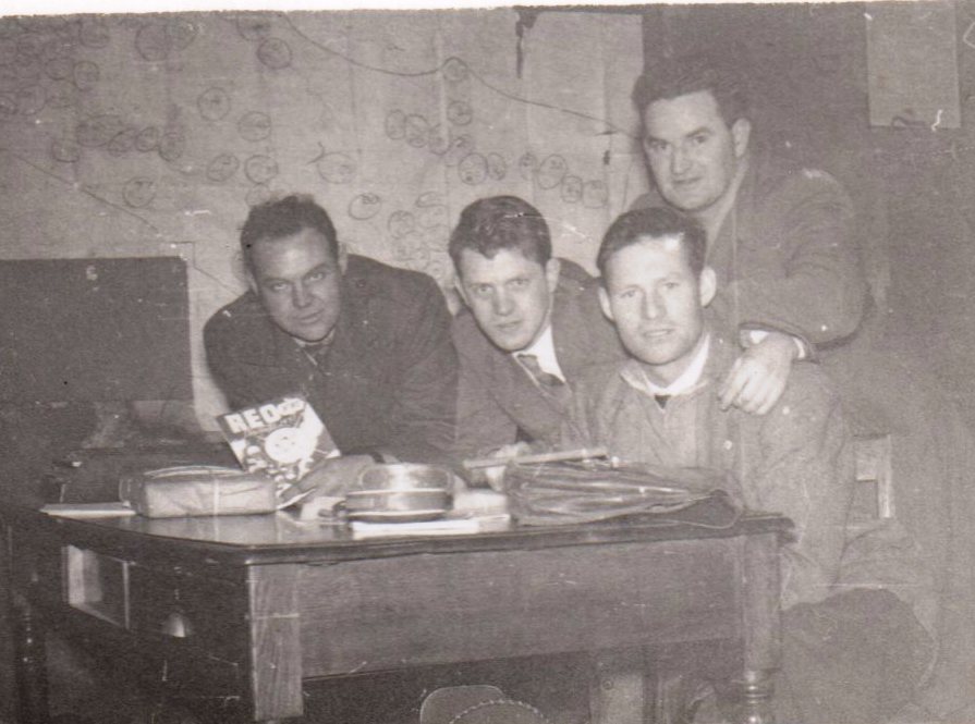 Tim Slevin with three ESB colleagues gathered around a table in an office setting, with maps and work materials visible in the background.