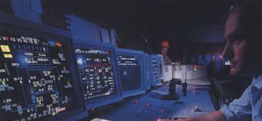 Control room at Great Island Power Station, showing operators monitoring computer displays and control systems.