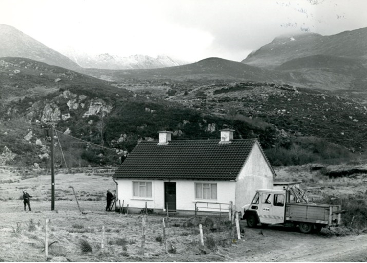 Utility workers connecting electrical infrastructure in a remote rural location.