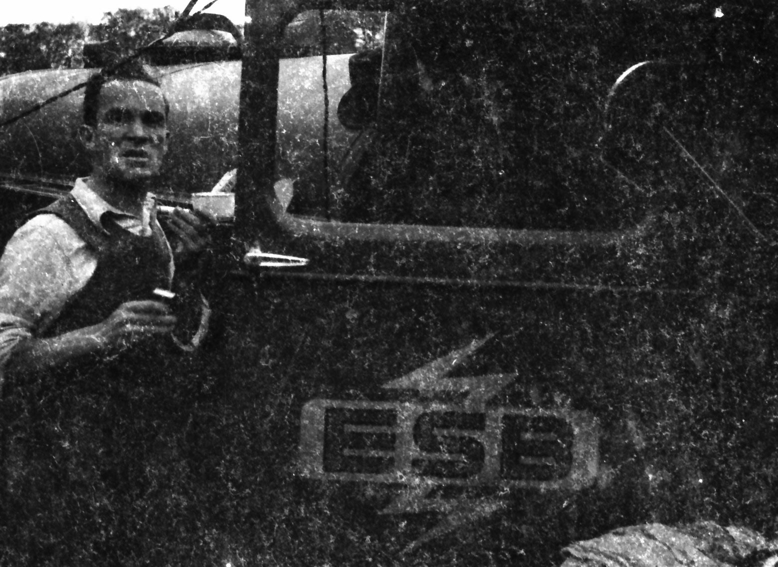 A rural worker pictured beside a vehicle, which bears ESB’s special Rural Electrification Scheme logo on its door.