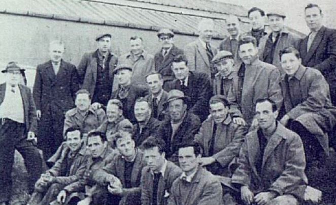 Dan Corbett and fellow ESB workers posing for a group photograph outside a building at Cork Polefield during the rural electrification programme.