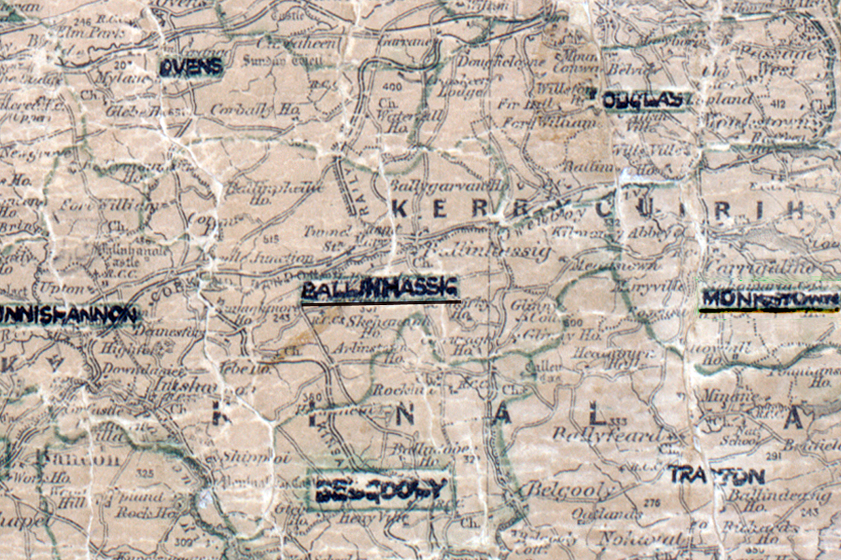 A scanned, worn historical map from the 1940s of the  rural electrification area around Ballinhassig. A hand‑drawn boundary outlines the region, including Ovens, Douglas, Innishannon, Monkstown, Belgooly and Tracton.