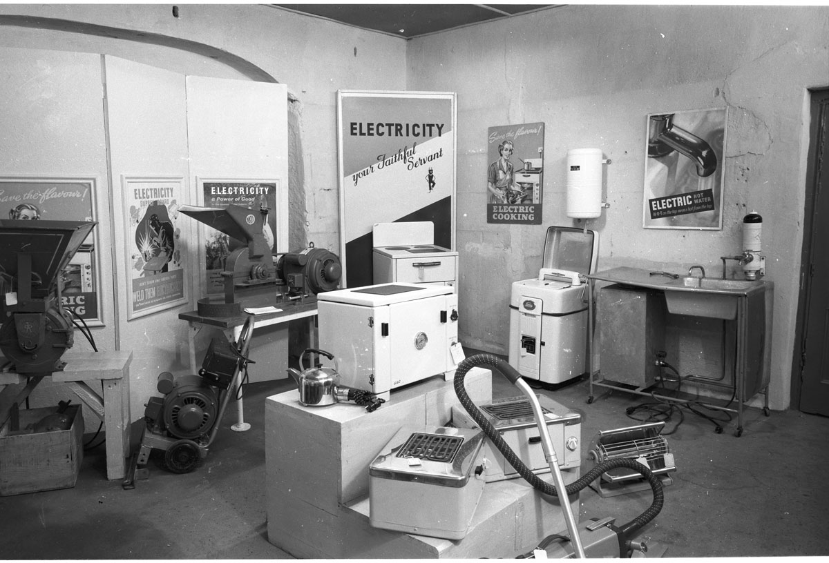 Black-and-white photograph showing a display of electrical appliances.
