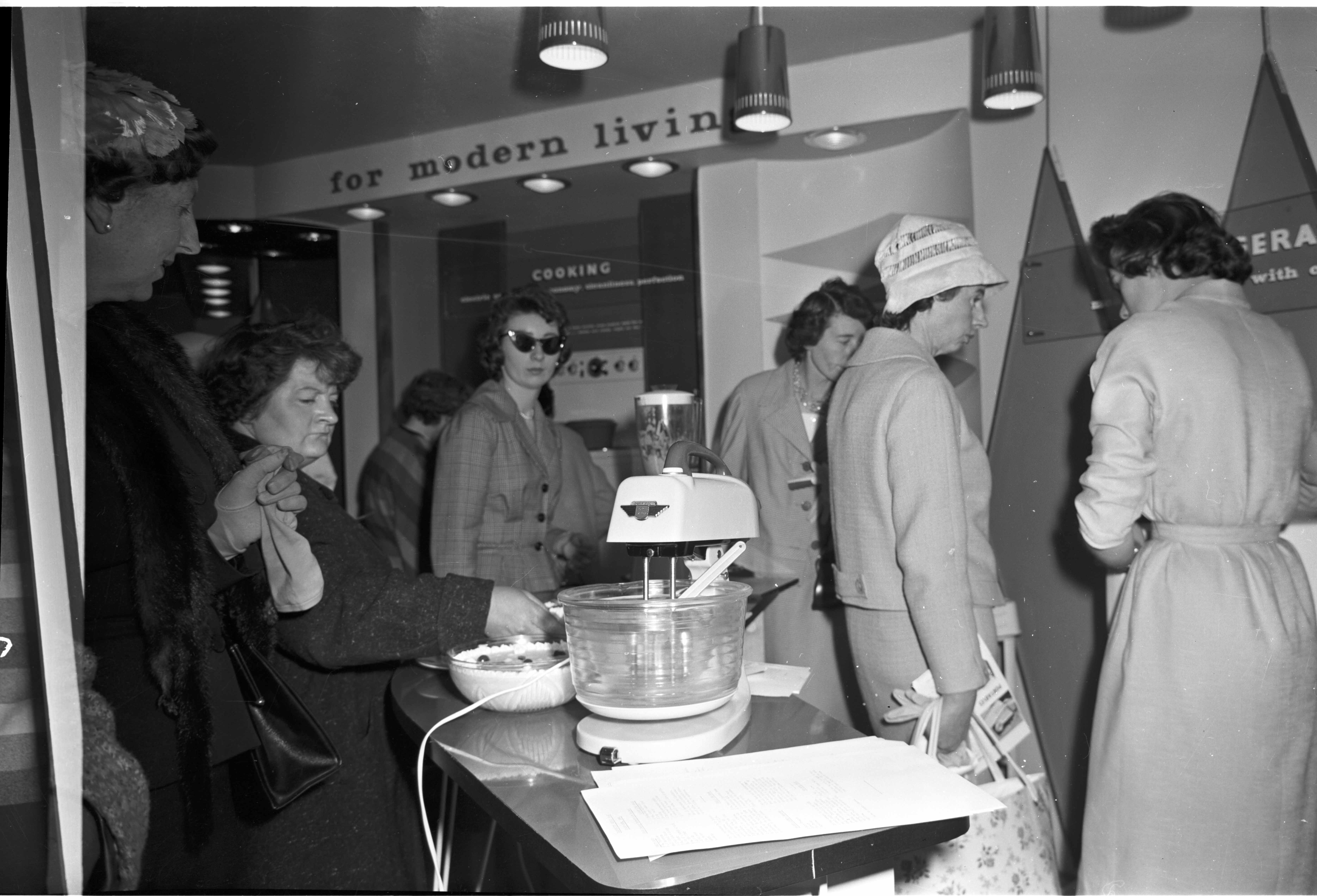 People standing inside a showroom for electrical appliances