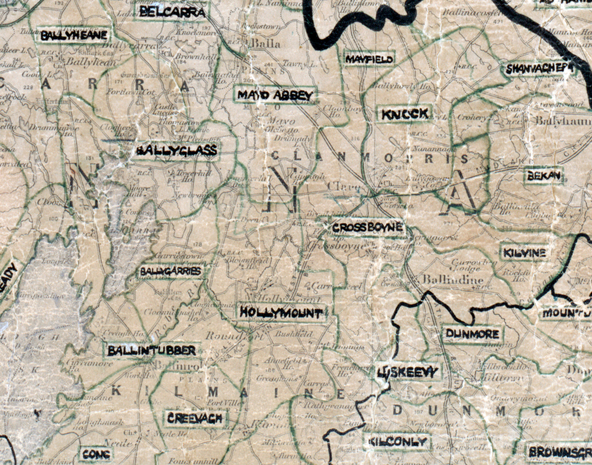 A scanned, worn historical map from the 1940s of the rural electrification area around Hollymount. A hand‑drawn boundary outlines the region, including Belcarra, Ballyheane, Mayfield,Bekan,  Ballintubber, CLiskeevy, Crevagh, and Kilcolny.