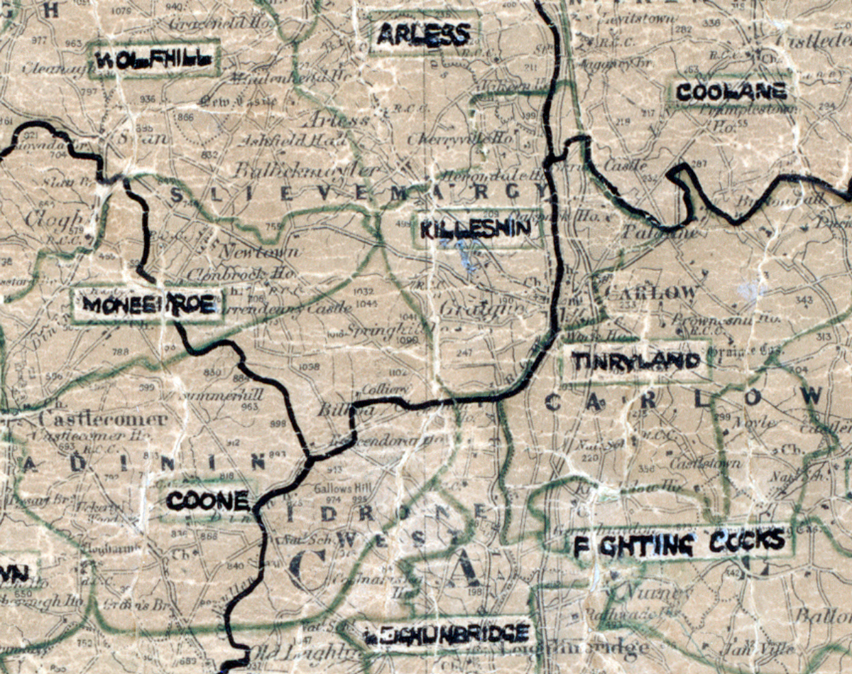 A scanned, worn historical map from the 1940s of the  rural electrification area around Killeshin. A hand‑drawn boundary outlines the region, including Wolfhill, Arless, Coolane, Monesroe, Tinryland, Carlow, Coone, Fighting Cocks and Schunbridge.