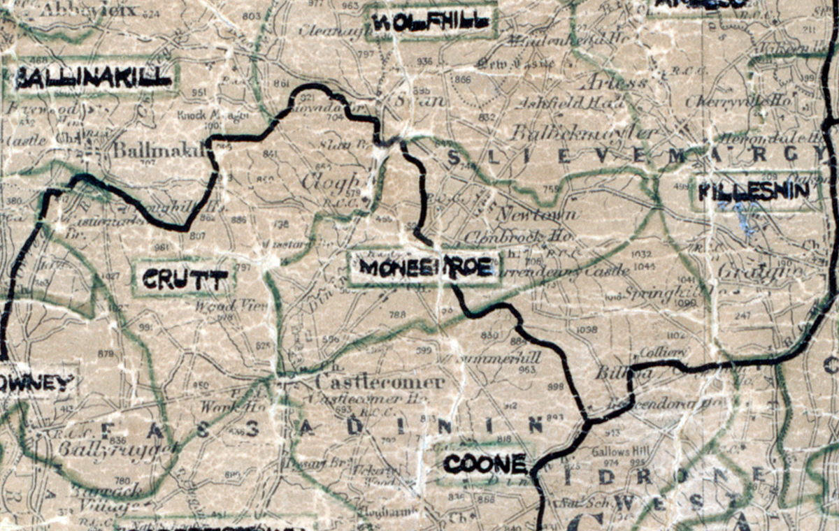 A scanned, worn historical map from the 1940s of the rural electrification area around Moneenroe. A hand‑drawn boundary outlines the region, including Ballinakill, Wolfhill, Crutt, Coone, and Kileshin.
