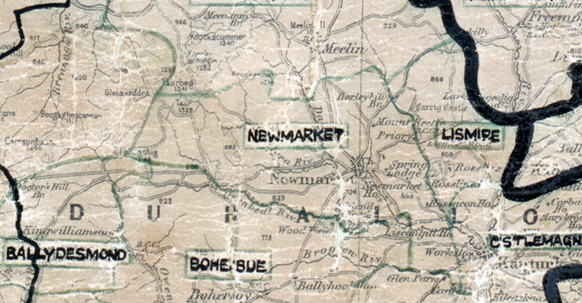 A scanned, worn historical map from the 1940s of the  rural electrification area around Newmarket. A hand‑drawn boundary outlines the region, including Ballyldesmond, Boherbue and Lismire.