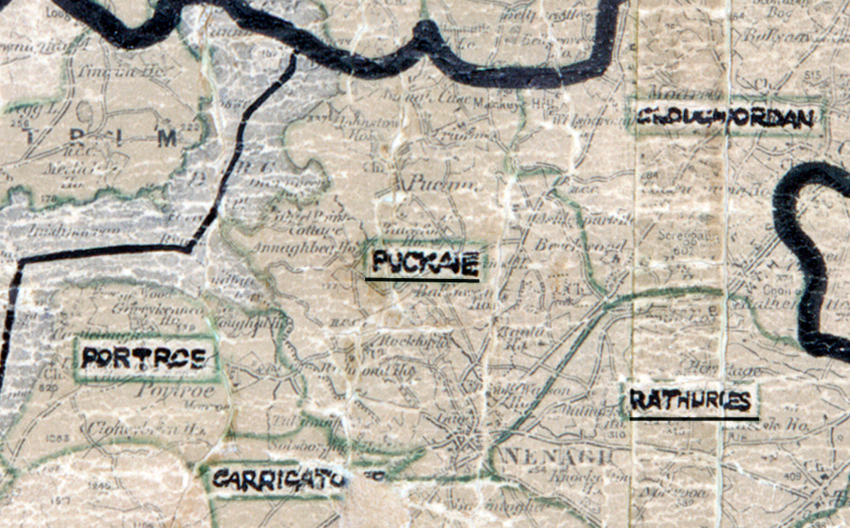 **“A scanned, worn historical map from the 1940s of the rural electrification area around Puckane. A hand‑drawn boundary outlines the region, including Portroe, Carrigatoher, and Rathurles.