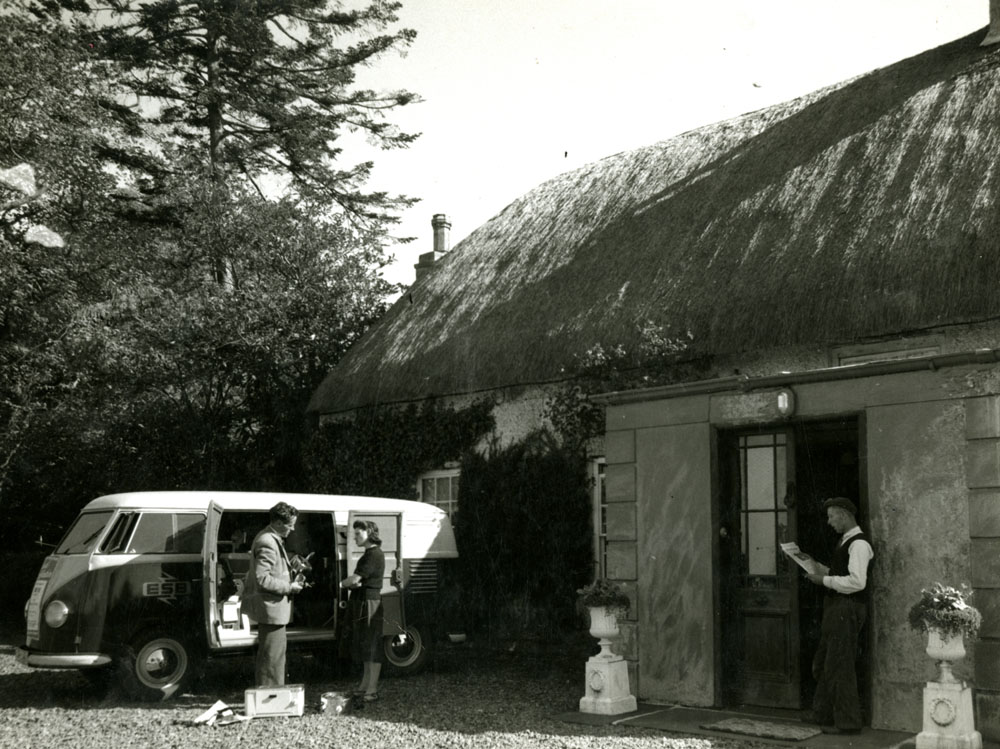 ESB van selling electrical appliances to people outside a cottage