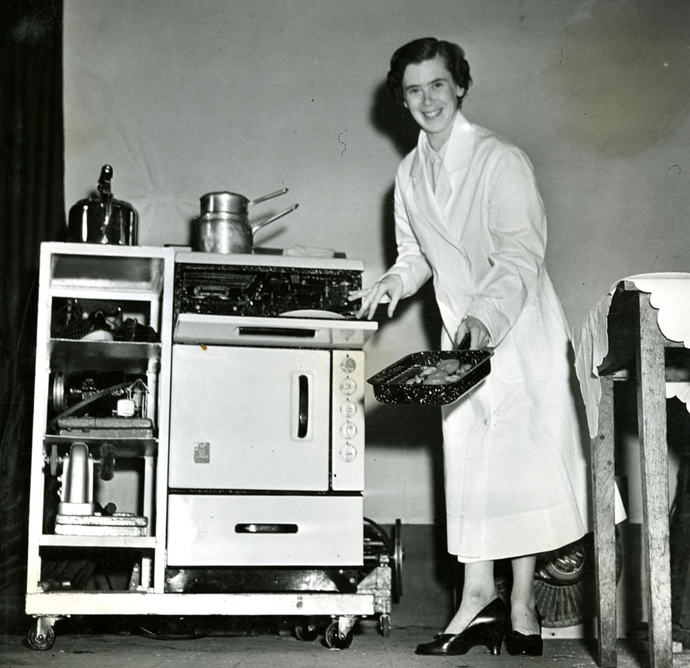 A woman standing beside her new electric stove