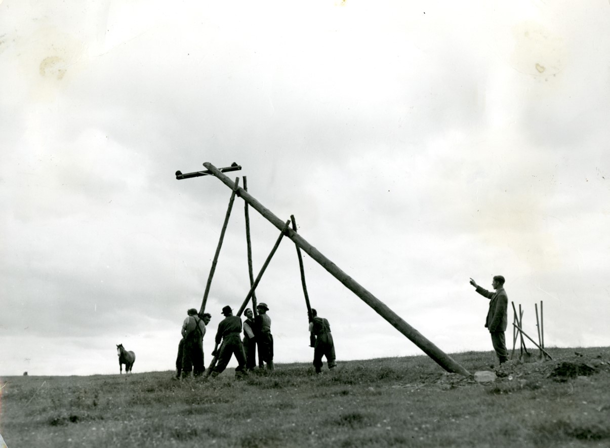 Workers putting up a pole