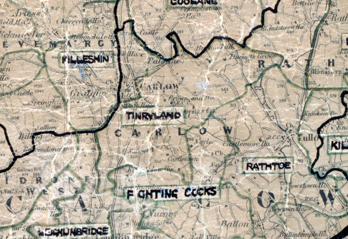 A scanned, worn historical map from the 1940s of the  rural electrification area around Tinryland. A hand‑drawn boundary outlines the region, including Coolmane, Filleskin, Fighting Cocks, Rathoe, Killeshin and Coonbridge.