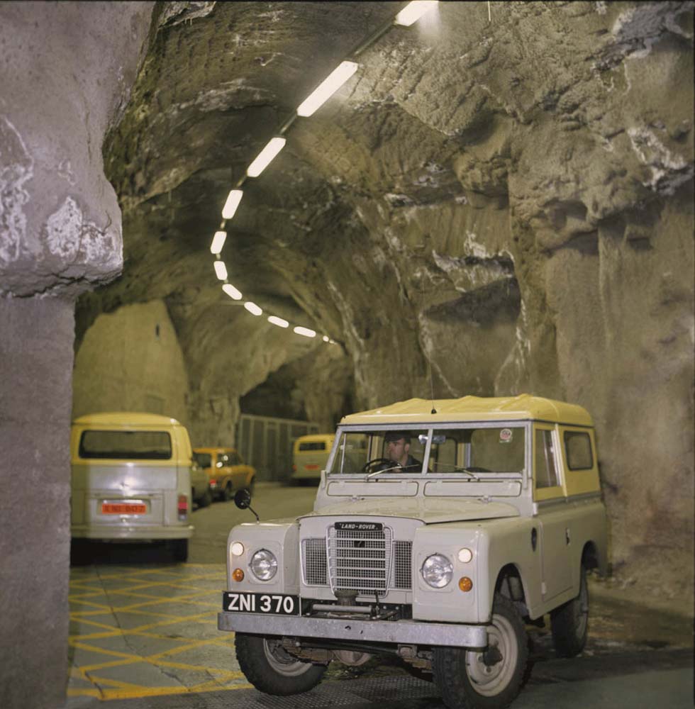 Colour photograph showing an ESB utility vehicle parked inside a rock-hewn underground tunnel, with additional service vehicles visible in the background.